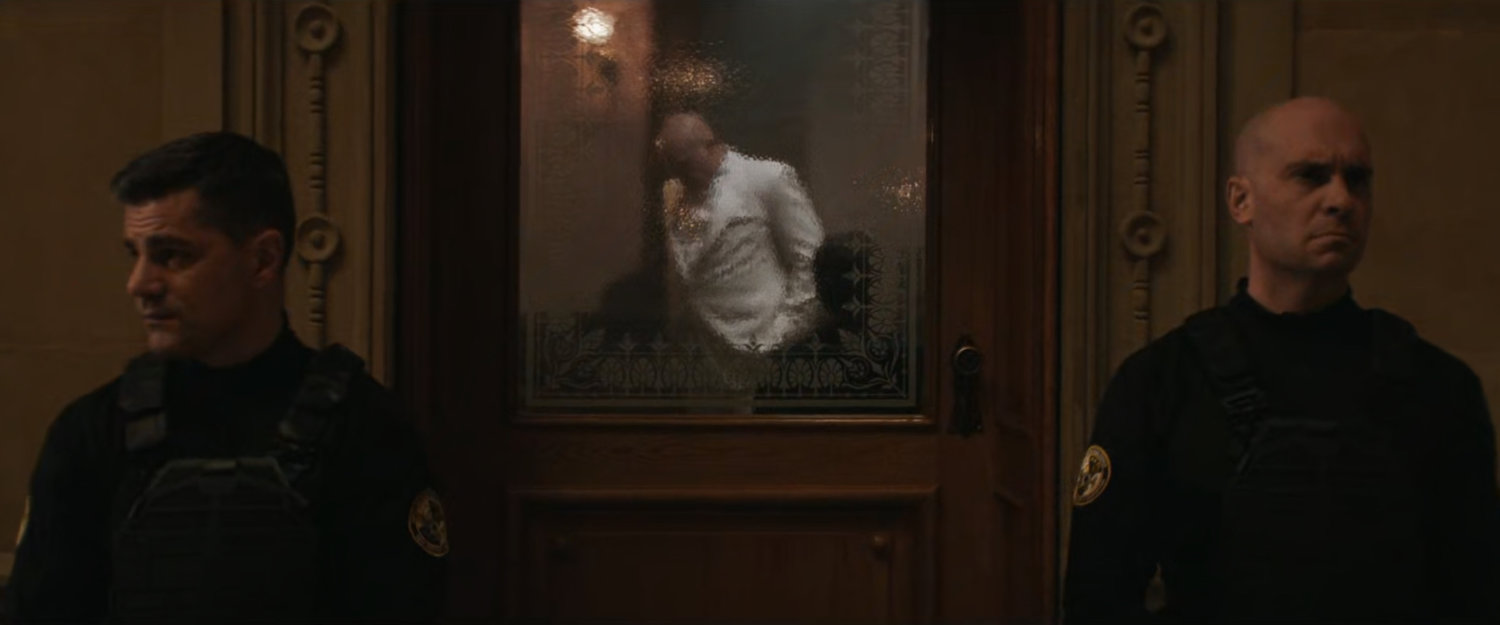 Fisk in an office guarded by two police officers at the Black & White Ball.