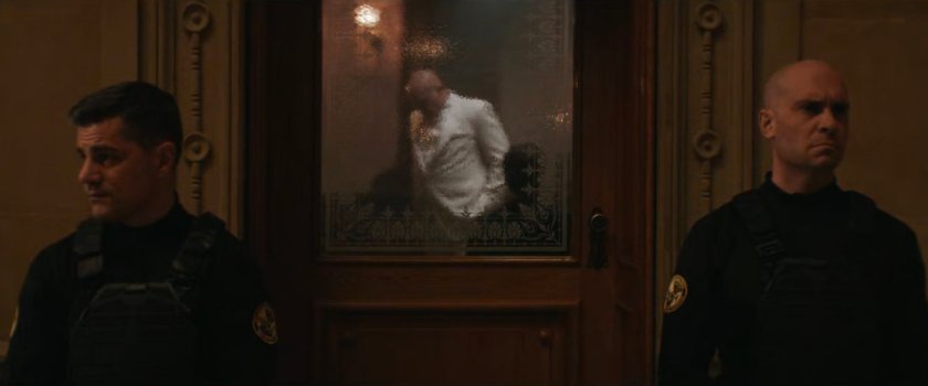 Fisk in an office guarded by two police officers at the Black & White Ball.