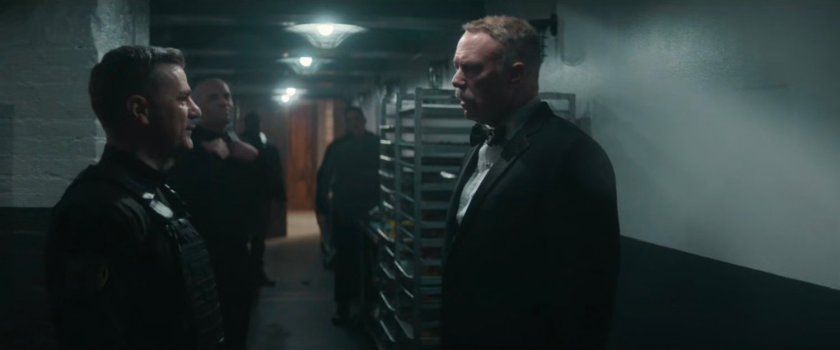 Officer Powell speaks with Chief Gallo in the kitchen at the Black & White Ball.