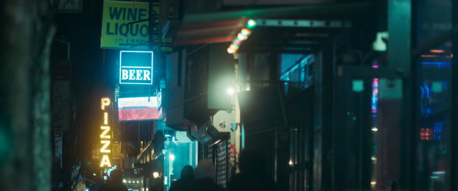 Interstitial: Liquor store fronts at night.