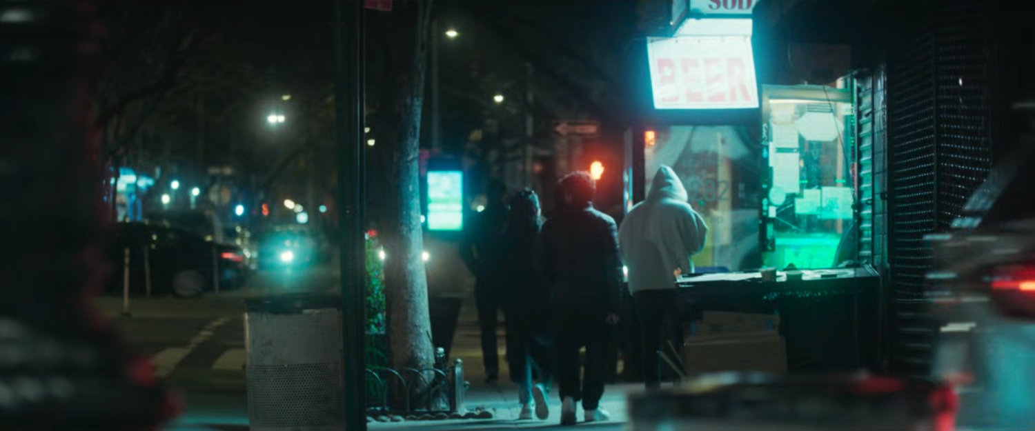 Interstitial: people on sidewalk at night.