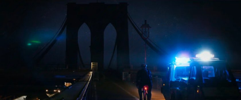 Interstitial: Cyclist on blacked out Brooklyn Bridge.