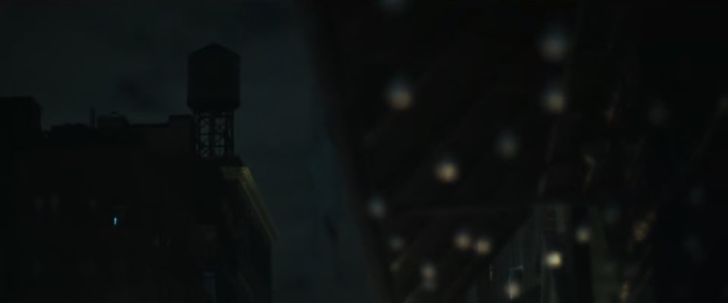 Interstitial: underside of awning with light bulbs and water tower.