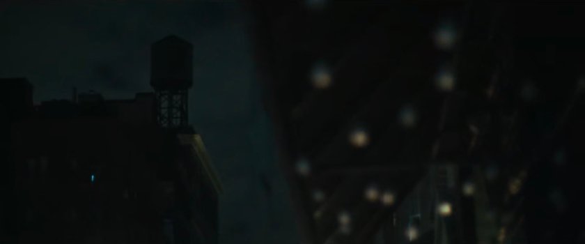 Interstitial: underside of awning with light bulbs and water tower.