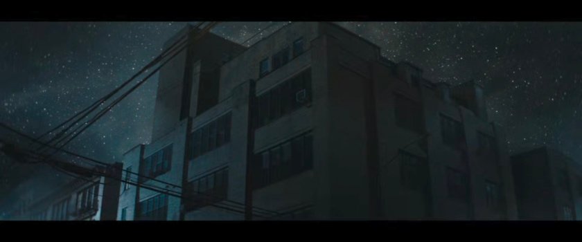 Nighttime exterior of Matt's apartment building.