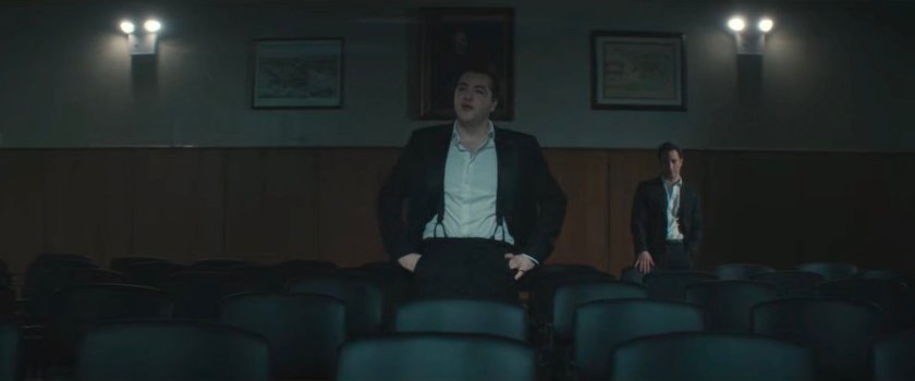 Daniel and Buck in a darkened City Council chamber.