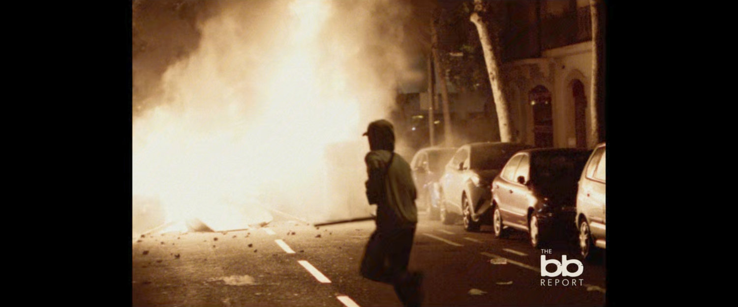 BB Report: footage of rioter running towards smoke.