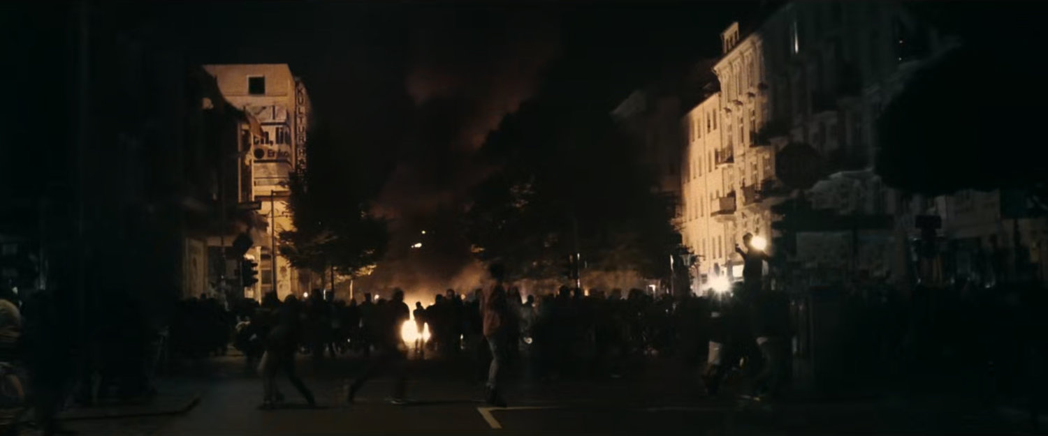 Interstitial: footage of people rioting in New York.