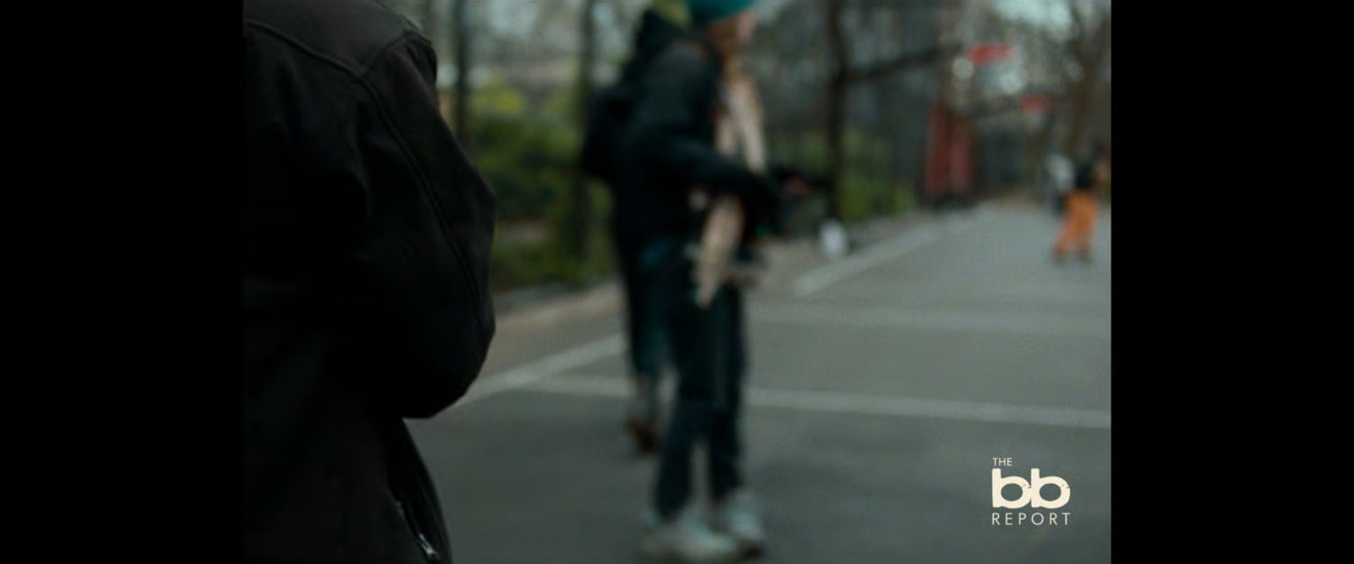 BB Report: out of focus people on sidewalk near park.