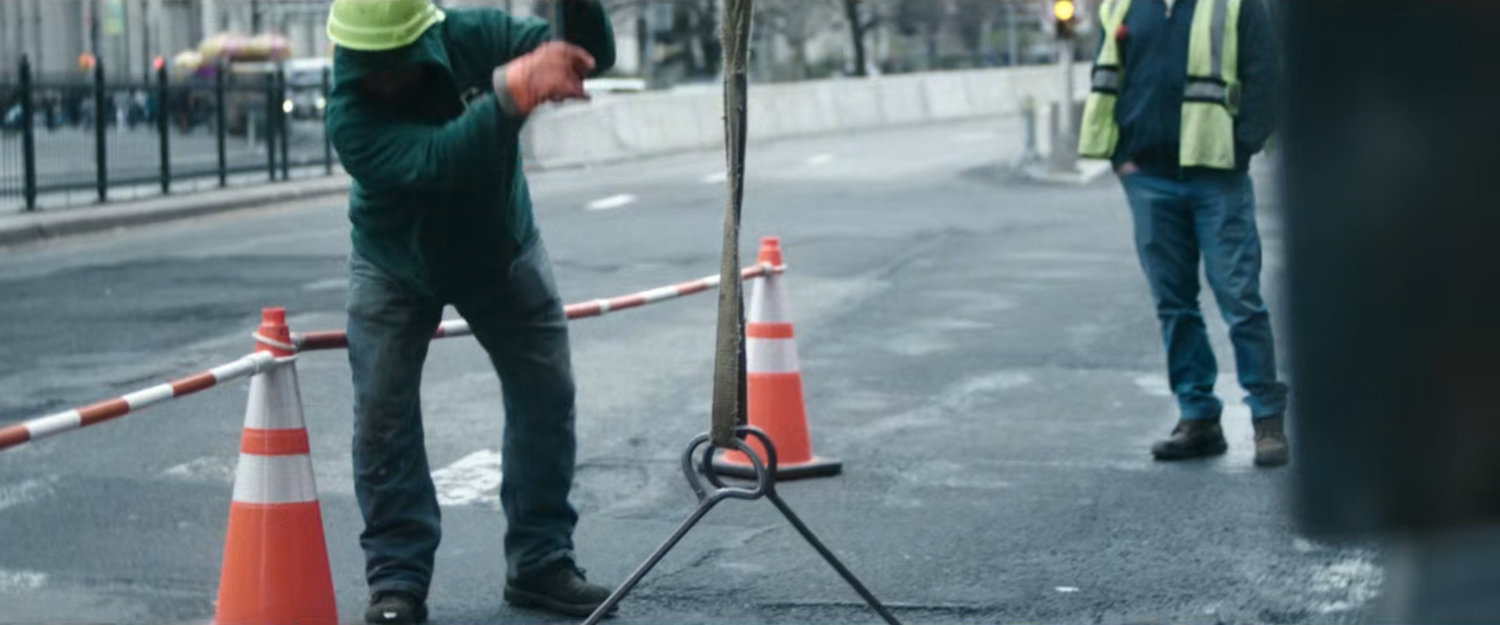 Interstitial: construction workers in road.