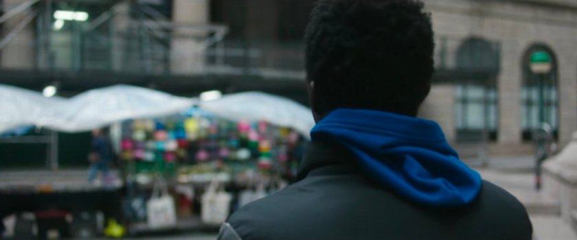 Interstitial: man looking at street vendor.