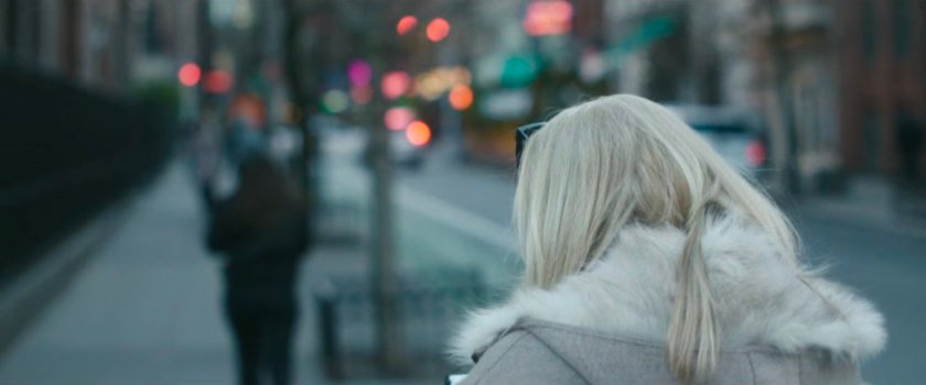 Interstitial: blonde woman walking along sidewalk.