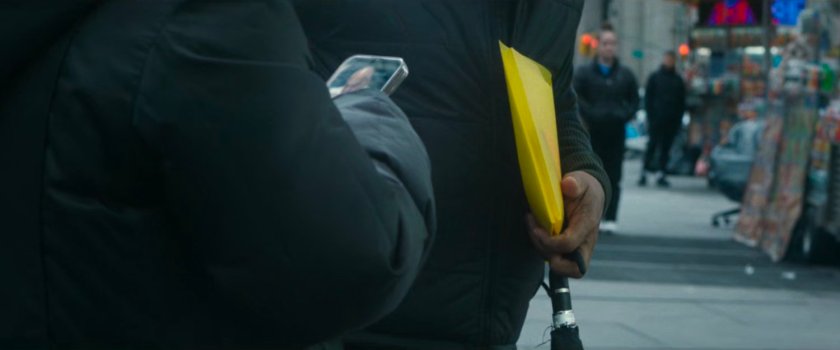 Interstitial: two people looking at phone by street vendor food carts.