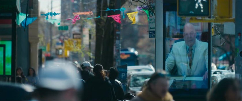 Interstitial: Mayor Fisk on video screen at sidewalk corner intersection.
