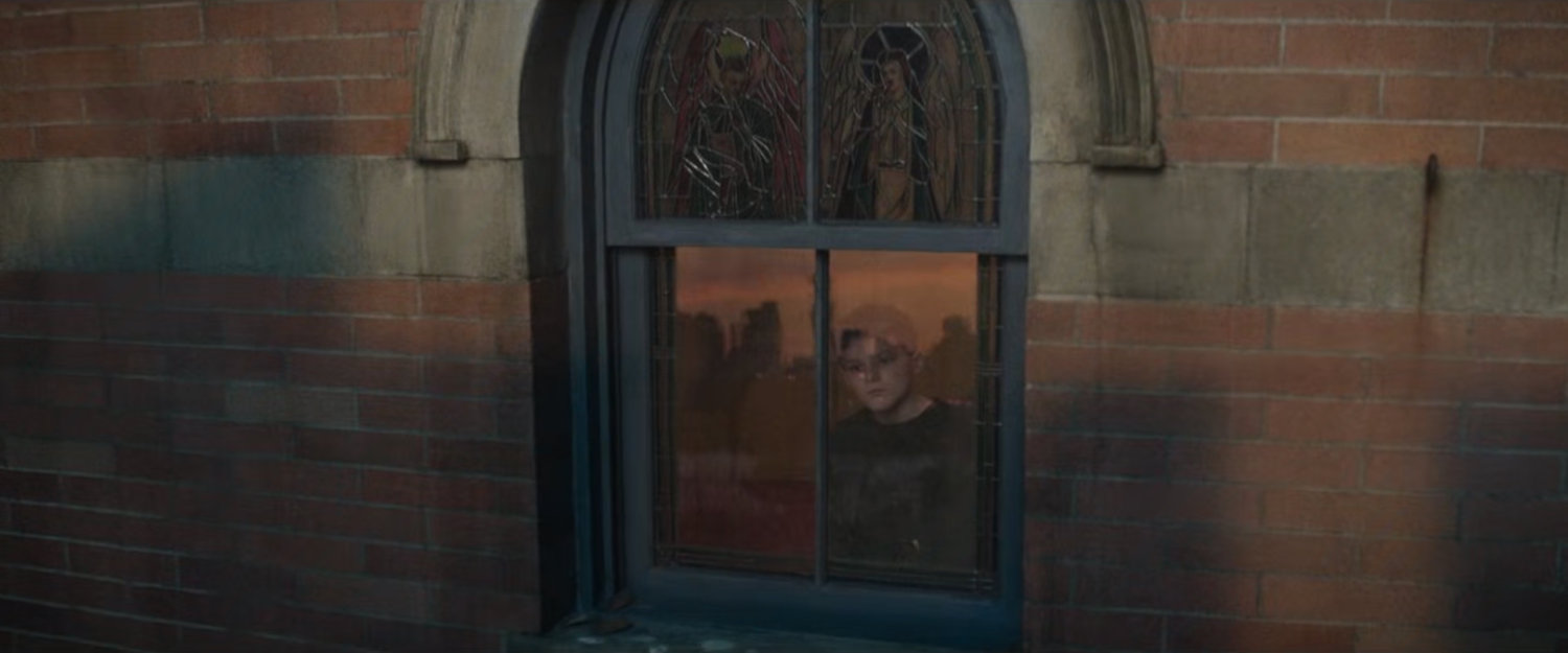 Young Matt looking out a church window at the city.