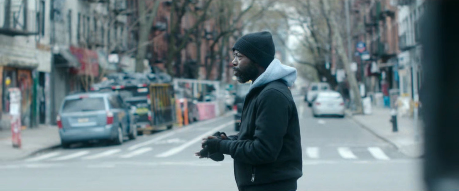 Interstitial: man crossing street.