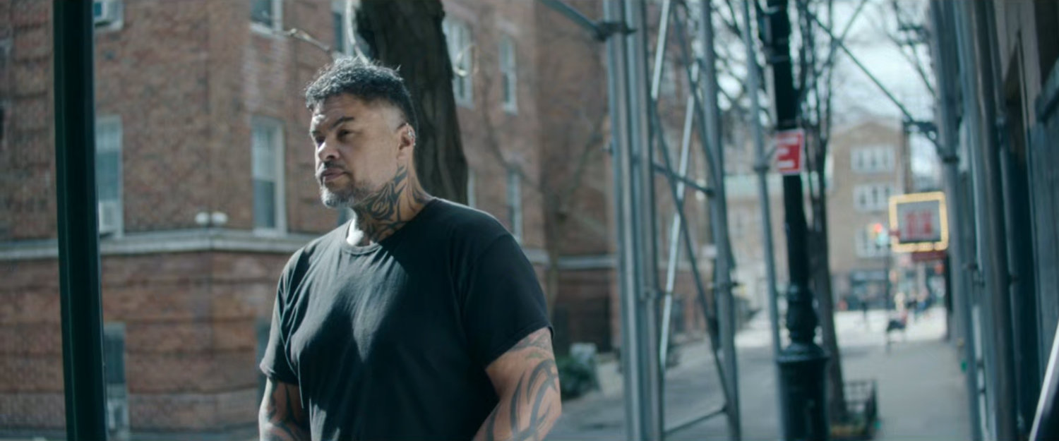 Interstitial: man with tattoo's on sidewalk.