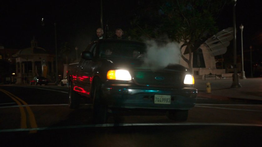 A Watchdog pickup truck driving through an intersection.