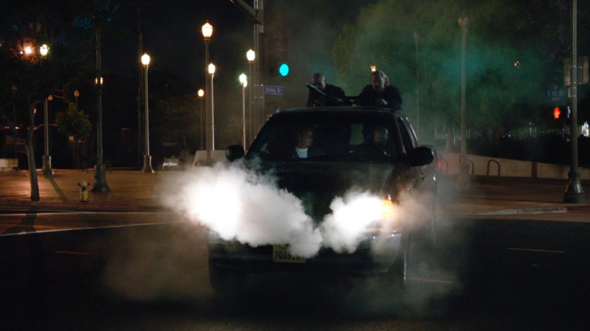 A smoking Watchdog pickup truck in an intersection.