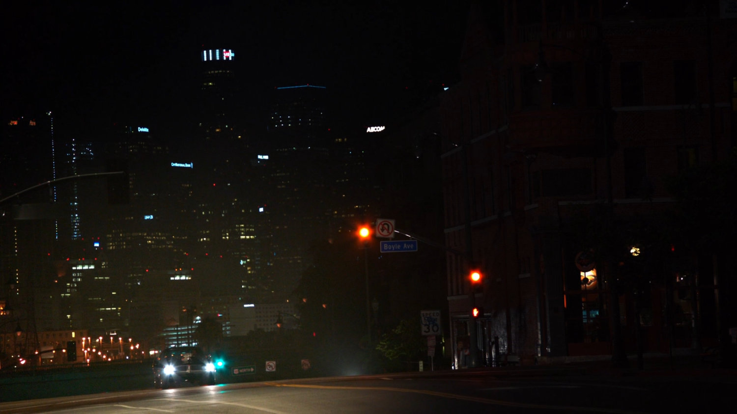 Ghost Rider's car driving along dark Los Angeles street.