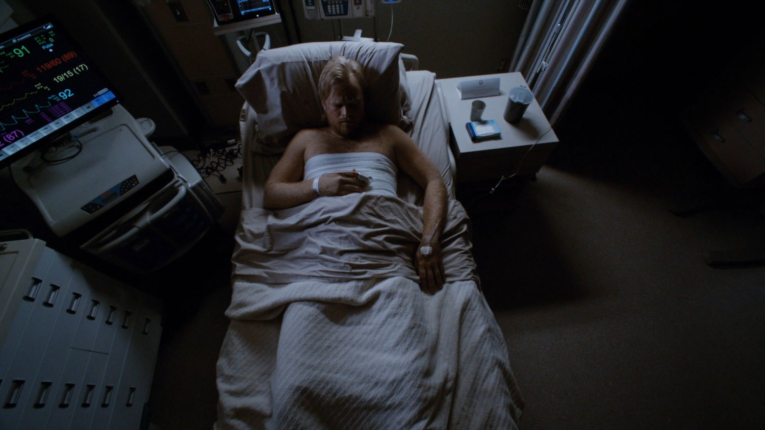Watchdog member laying in hospital bed.
