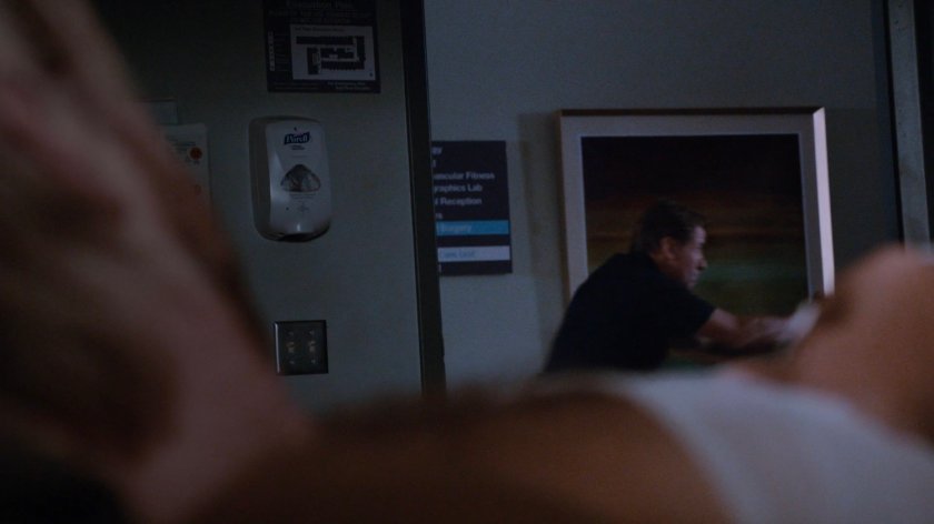 Hospital orderly in hall outside room.