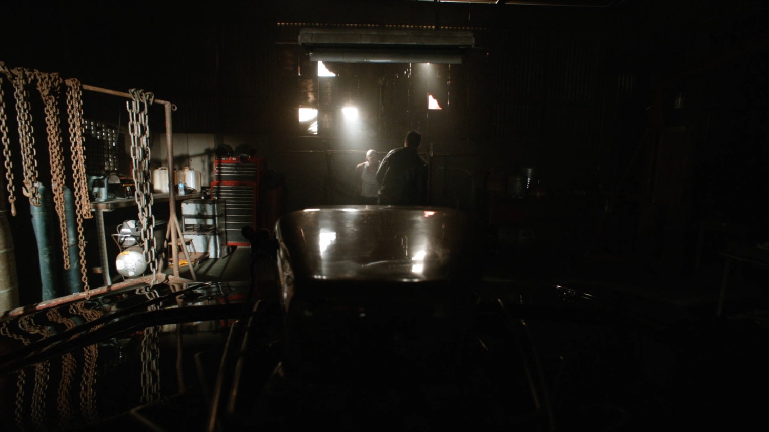 Robbie Reyes in a garage with a member of the Watchdogs.