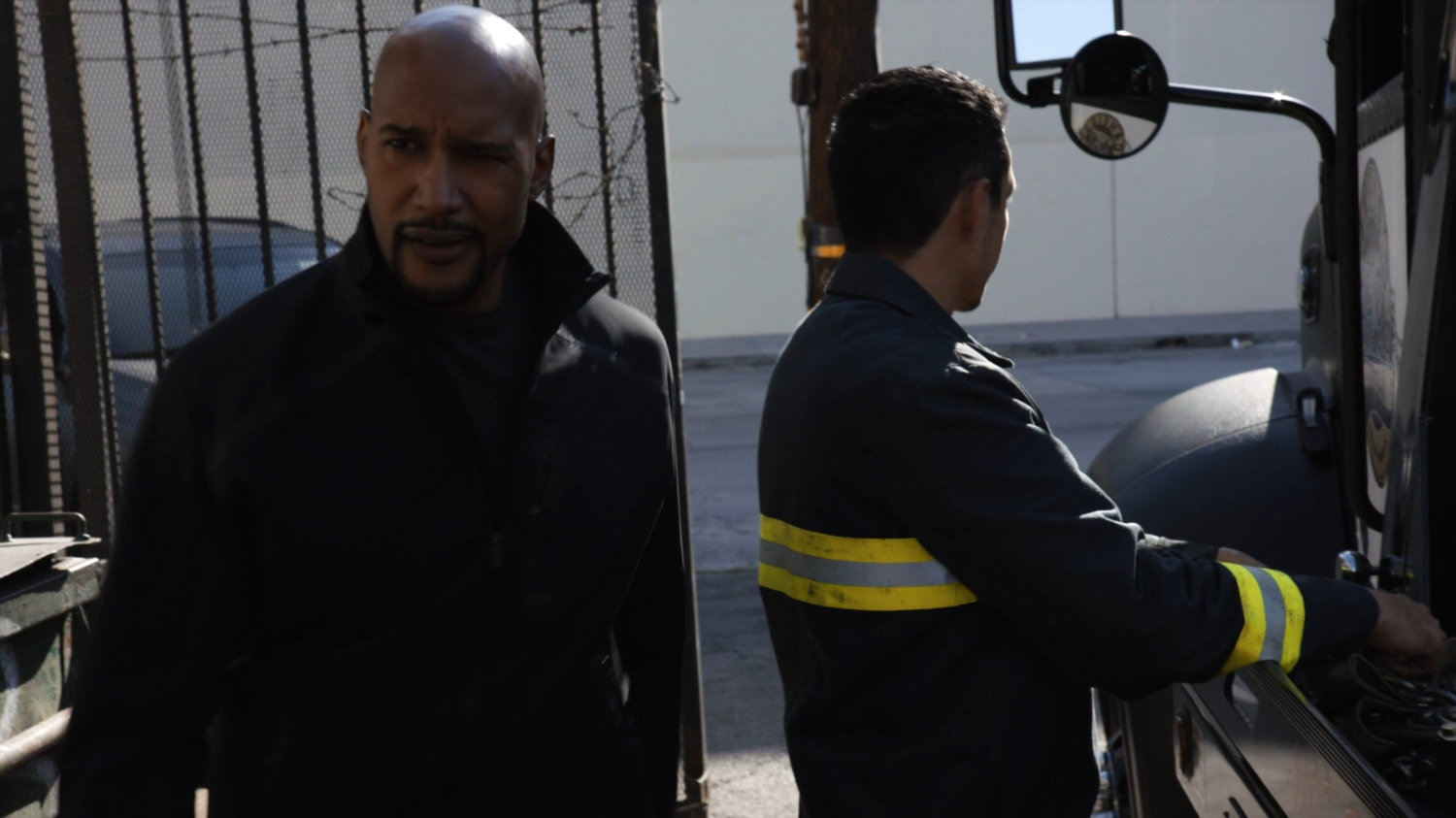 Mack passes by Robbie Reyes outside the warehouse.