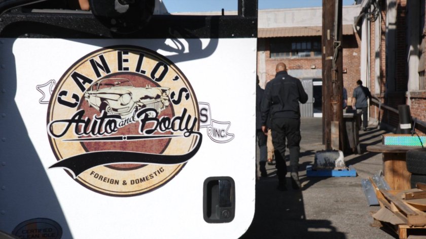 Mack and Coulson walking to warehouse past truck from Canelo's Auto and Body.