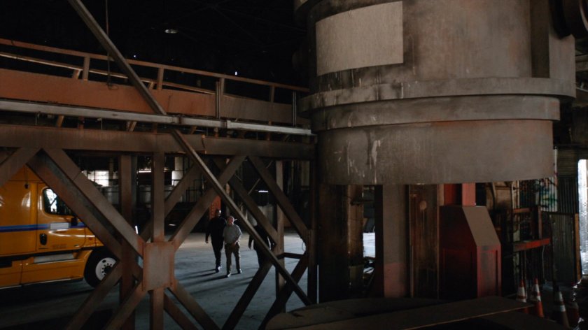 SHIELD agents approach an 18-wheeler in a warehouse.