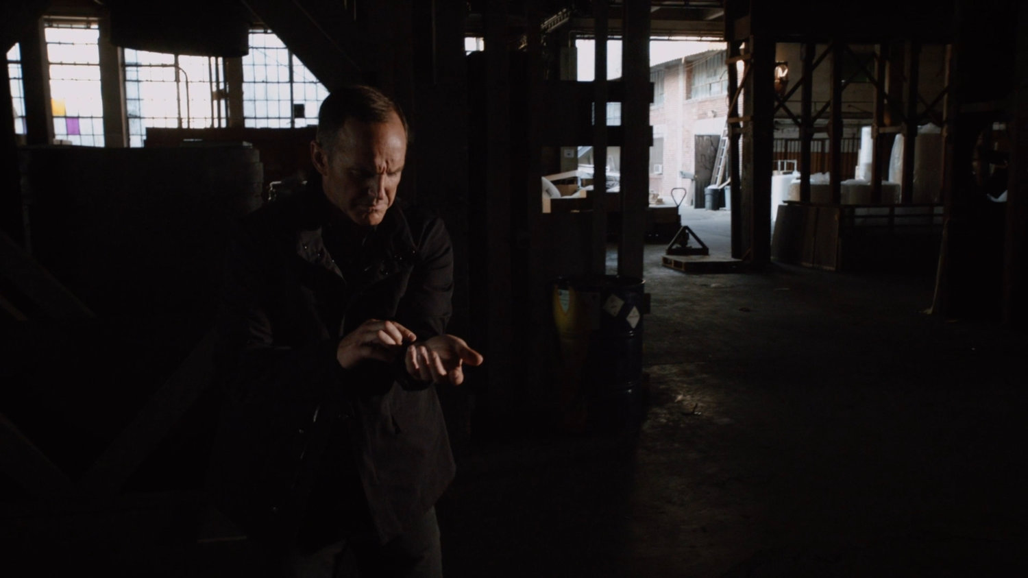 Coulson inside an abandoned warehouse.