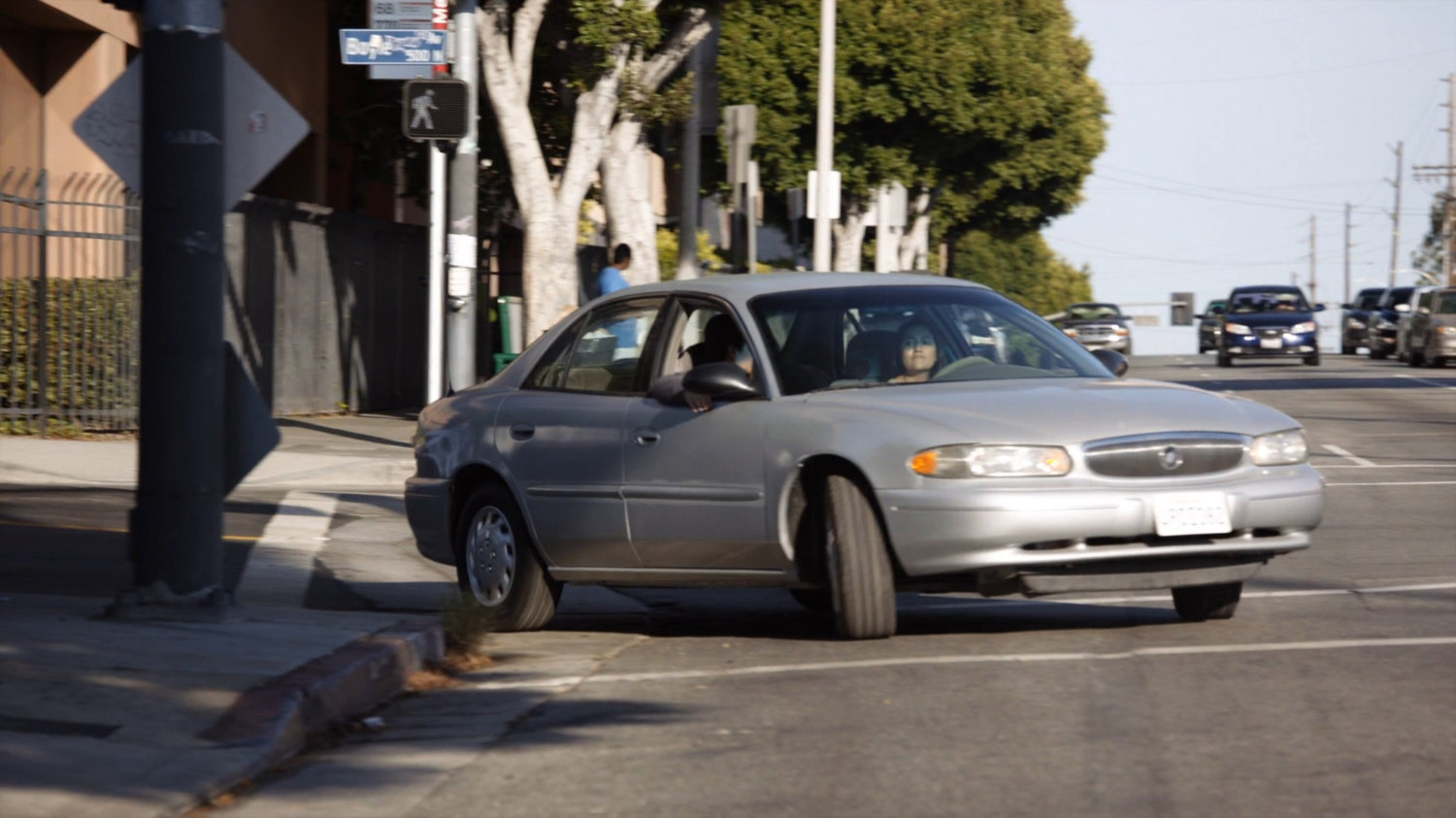 Car turning corner outside Canelo's Auto and Body.