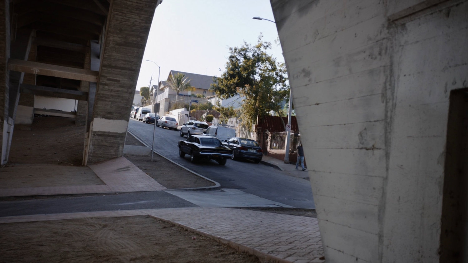 Robbie's black Charger driving away from his house.