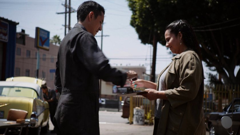 Robbie and a female customer in front of Canelo's Auto & Body.