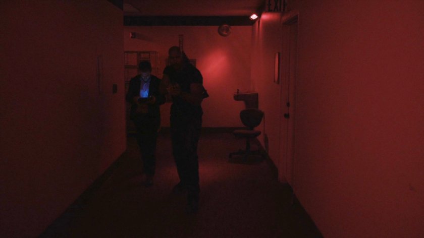 Fitz and Mack in red lit interior hallway in Momentum Labs.