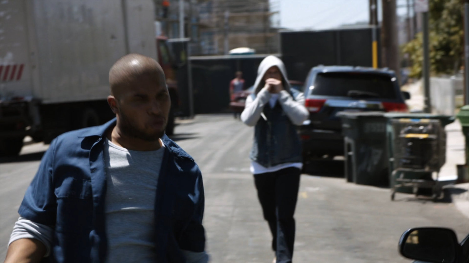 Rioters walking along street.