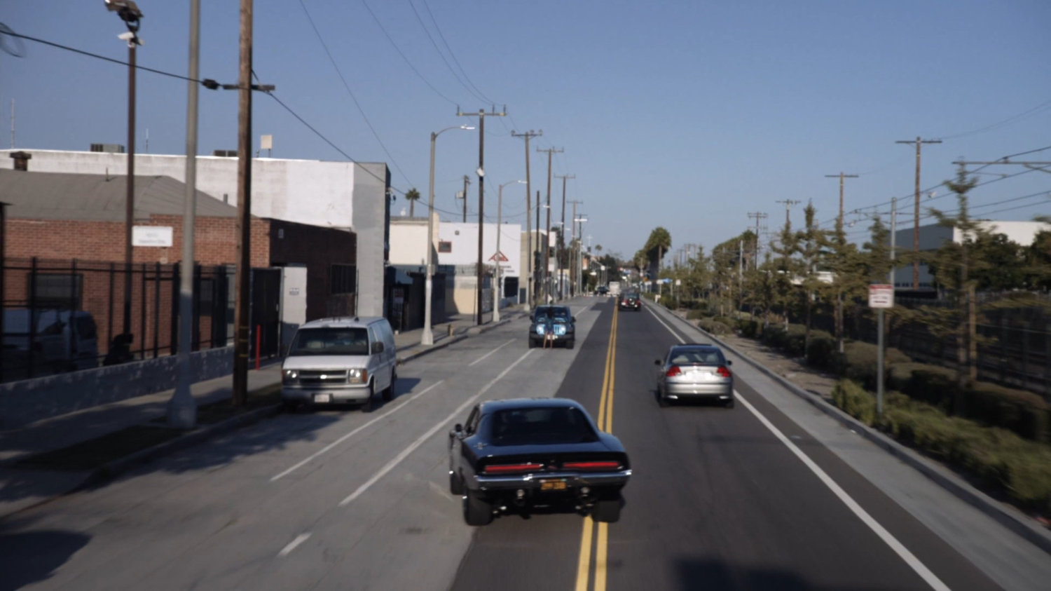 Black Charger driving on street.