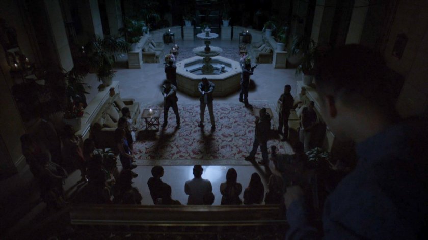 Watchdogs hold guns on people in blacked out Miami hotel lobby.