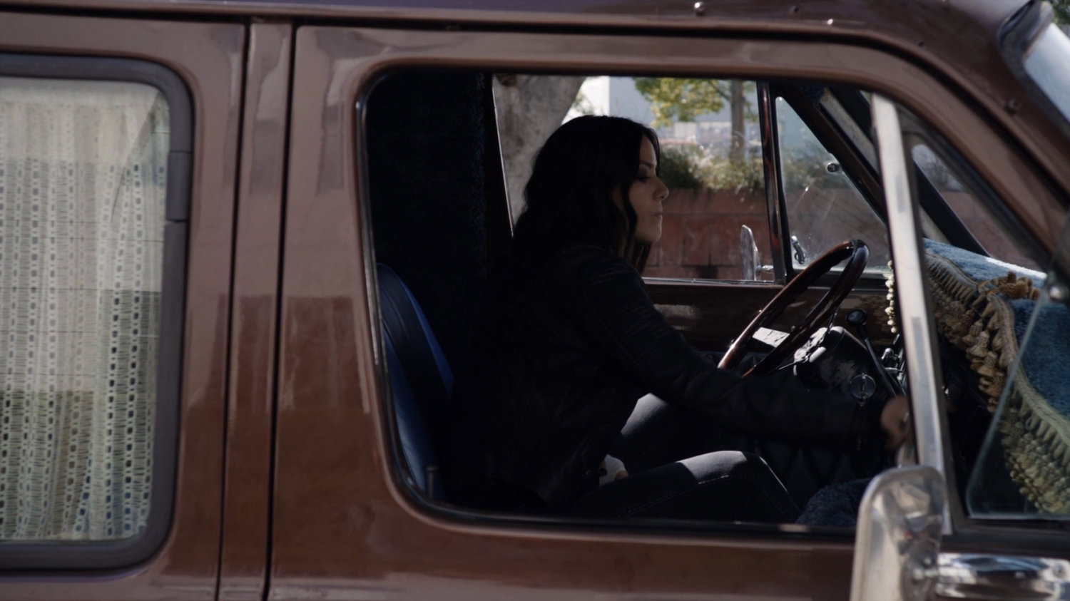 Daisy sitting in her van.