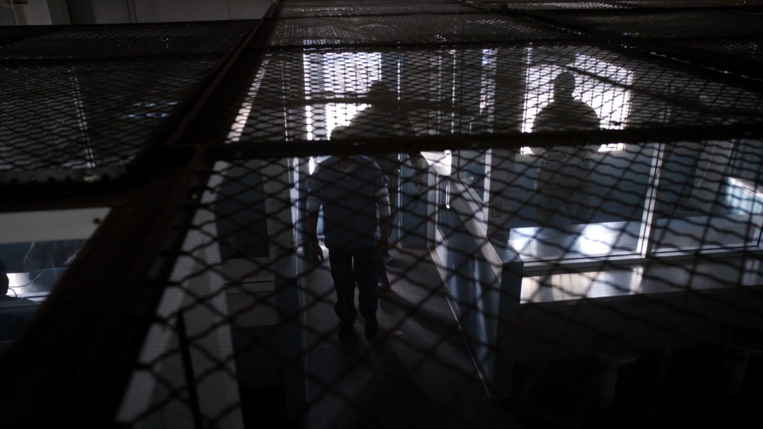 High angle view through cage in South Ridge Penitentiary visitor room.