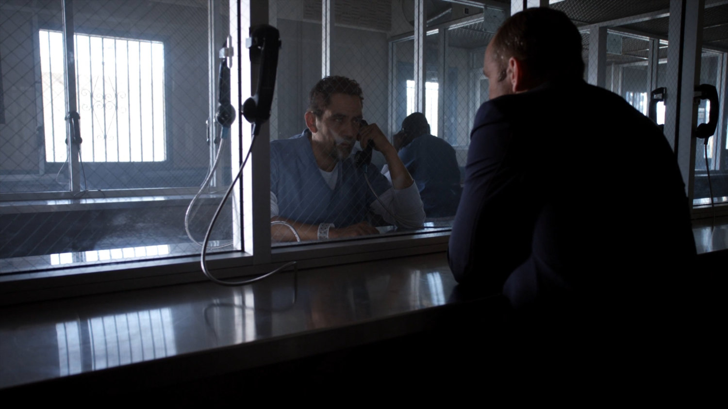Eli and Coulson in visitor room at South Ridge Penitentiary.