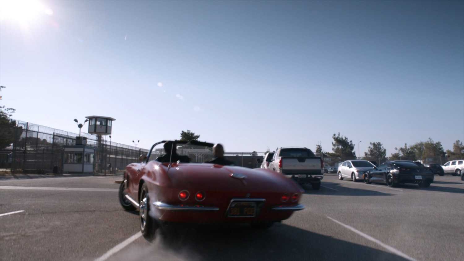 Lola driving through South Ridge Penitentiary parking lot.