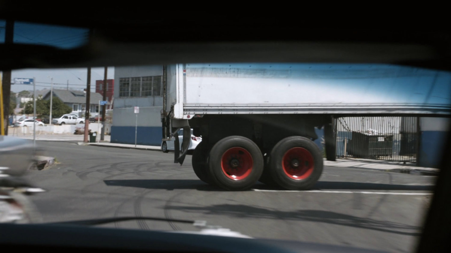 POV from black Charger of backing semi-truck.