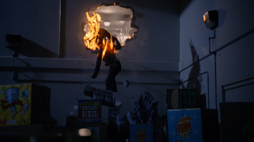 Ghost Rider fighting JT James through hole from storage lockers into Primed and Ready Fireworks.