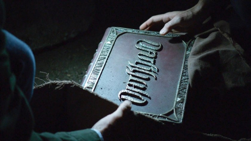Joseph and Lucy Bauer hold the Darkhold book in a dark basement.