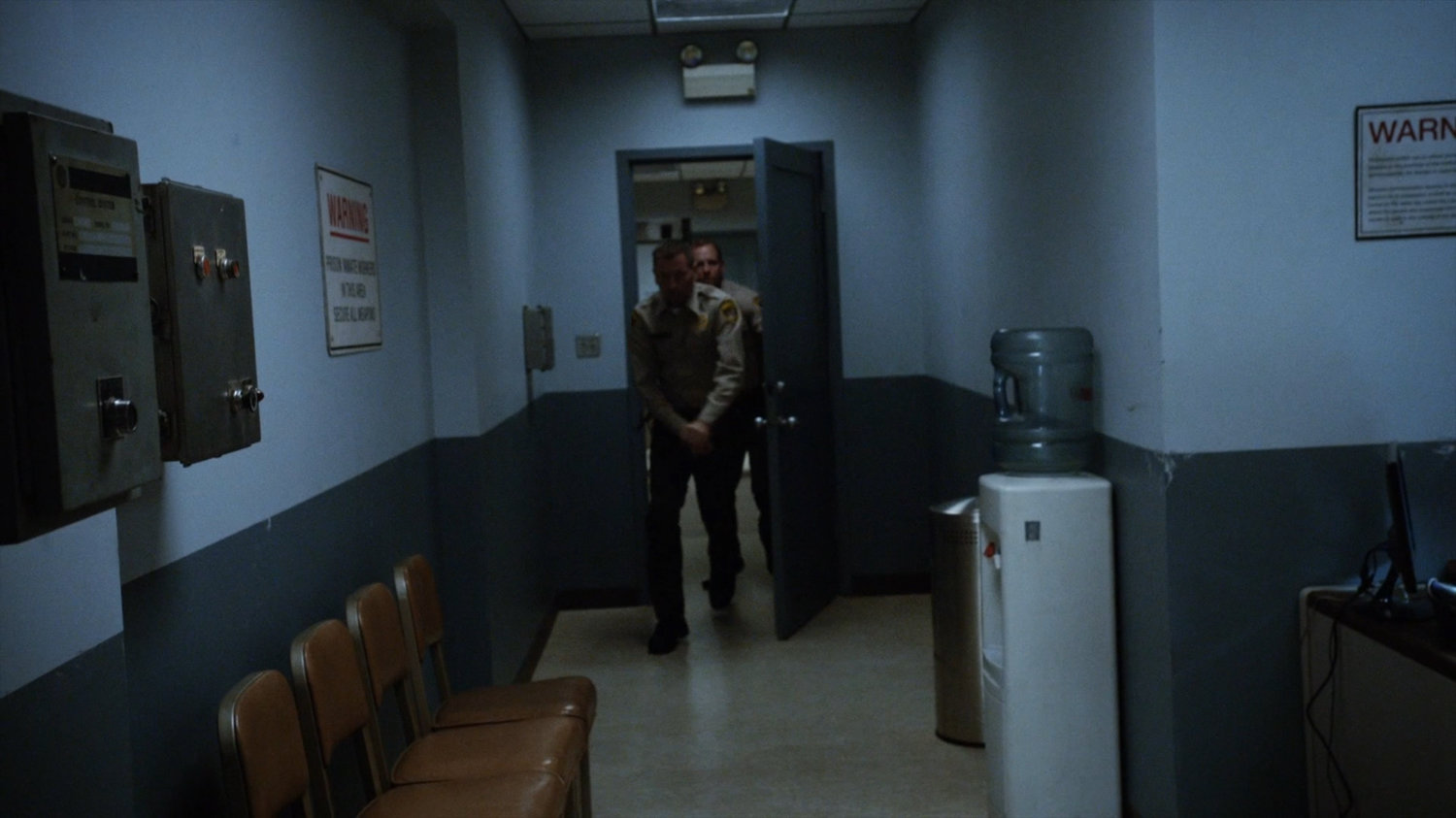 Guards entering hallway outside Warden Green's office at South Ridge Penitentiary.