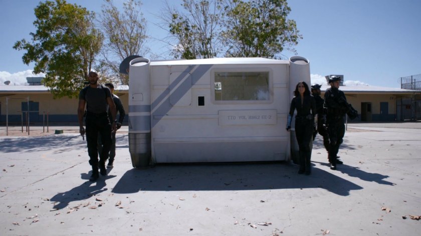 SHIELD agents exiting containment module on a basketball court at South Ridge Penitentiary.