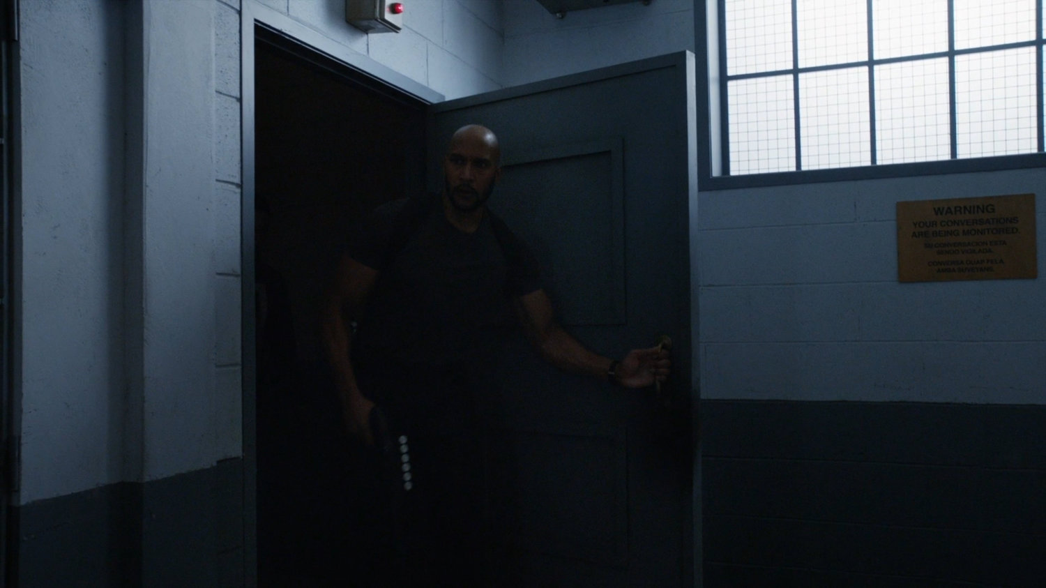 Mack entering cell block D of South Ridge Penitentiary.