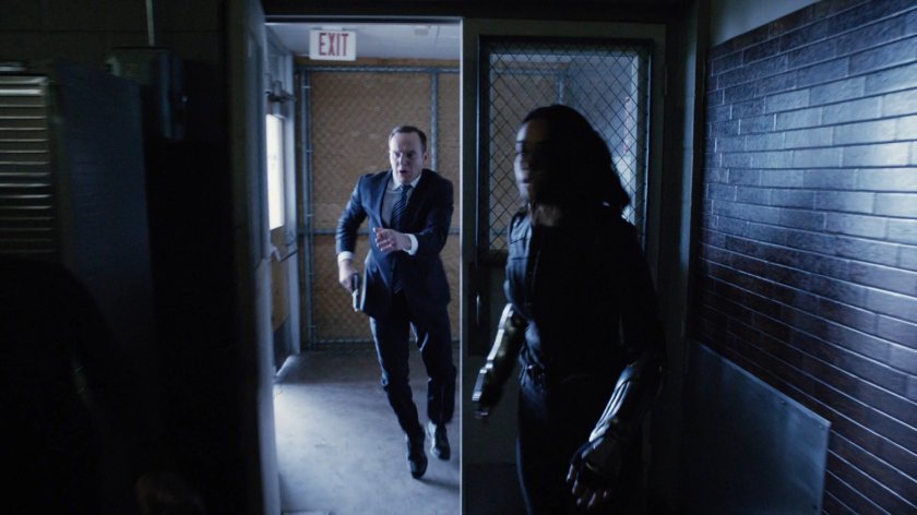 Coulson and Daisy running into the cafeteria at South Ridge Penitentiary.