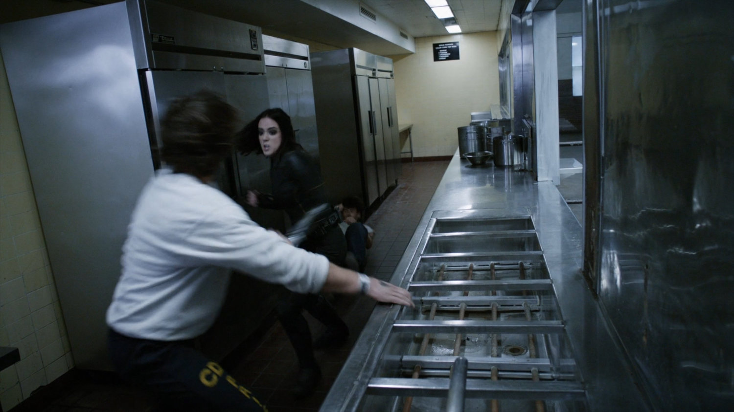 Daisy fights prisoners in kitchen of the cafeteria at South Ridge Penitentiary.